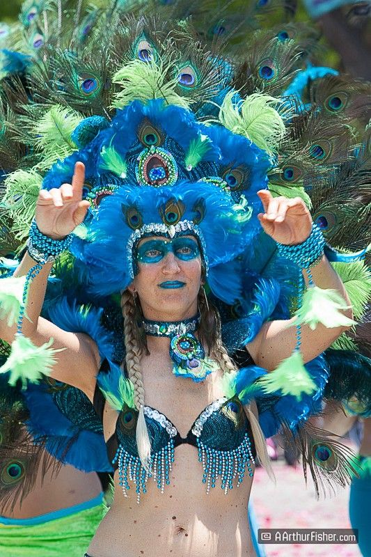 Photo of woman in headdress marching in parade